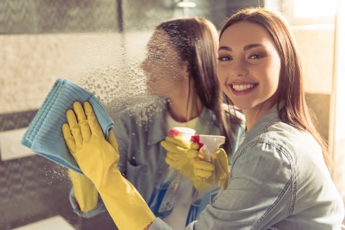 Cleaner making up a bed during Airbnb cleaning in Acton